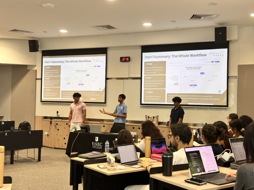 Yibo, Nirvan and Rishabh presenting the Part 1 summary slide to a lecture room of ESSEC students working on laptops.